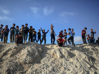 Children are looking on as people attend a mass wedding ceremony in Khan Yunis, in the southern Gaza Strip, on May 3, 2024, amid the ongoing...