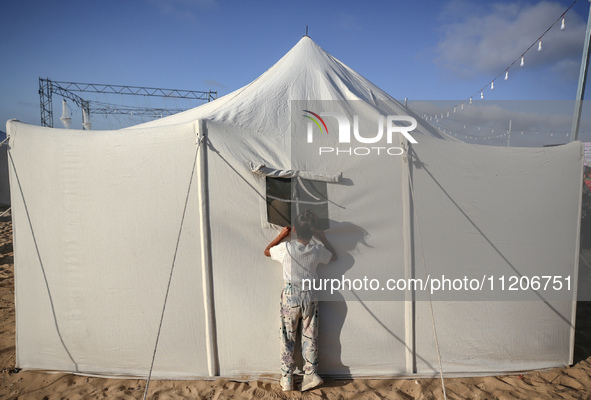 A Palestinian girl is attending a wedding among makeshift tents in Khan Younis, in the southern Gaza Strip, on May 3, 2024, amid the ongoing...