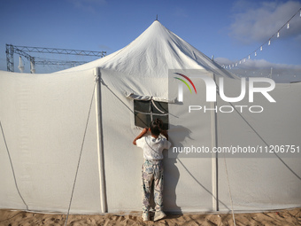 A Palestinian girl is attending a wedding among makeshift tents in Khan Younis, in the southern Gaza Strip, on May 3, 2024, amid the ongoing...