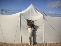 A Palestinian girl is attending a wedding among makeshift tents in Khan Younis, in the southern Gaza Strip, on May 3, 2024, amid the ongoing...