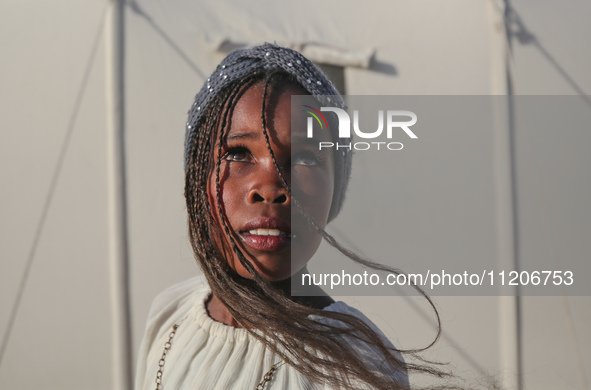 A Palestinian girl is attending a wedding among makeshift tents in Khan Younis, in the southern Gaza Strip, on May 3, 2024, amid the ongoing...