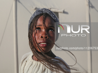 A Palestinian girl is attending a wedding among makeshift tents in Khan Younis, in the southern Gaza Strip, on May 3, 2024, amid the ongoing...