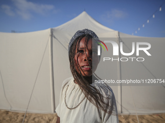 A Palestinian girl is attending a wedding among makeshift tents in Khan Younis, in the southern Gaza Strip, on May 3, 2024, amid the ongoing...