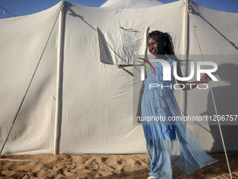 A Palestinian girl is attending a wedding among makeshift tents in Khan Younis, in the southern Gaza Strip, on May 3, 2024, amid the ongoing...