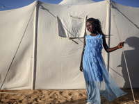 A Palestinian girl is attending a wedding among makeshift tents in Khan Younis, in the southern Gaza Strip, on May 3, 2024, amid the ongoing...