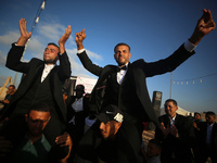 Displaced Palestinians are attending a mass wedding ceremony in Khan Yunis, in the southern Gaza Strip, on May 3, 2024, amid the ongoing con...