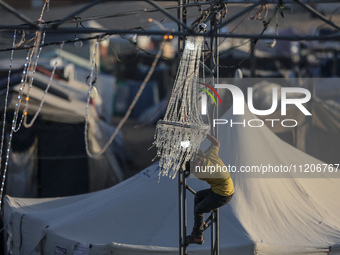 A Palestinian girl is attending a wedding among makeshift tents in Khan Younis, in the southern Gaza Strip, on May 3, 2024, amid the ongoing...