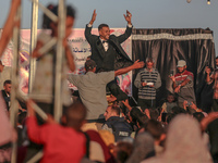 Grooms are celebrating during a mass wedding ceremony in Khan Yunis, in the southern Gaza Strip, on May 3, 2024, amid the ongoing conflict b...