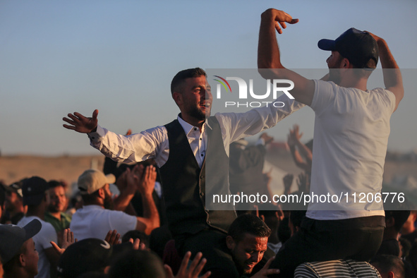 Grooms are celebrating during a mass wedding ceremony in Khan Yunis, in the southern Gaza Strip, on May 3, 2024, amid the ongoing conflict b...