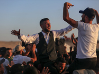 Grooms are celebrating during a mass wedding ceremony in Khan Yunis, in the southern Gaza Strip, on May 3, 2024, amid the ongoing conflict b...