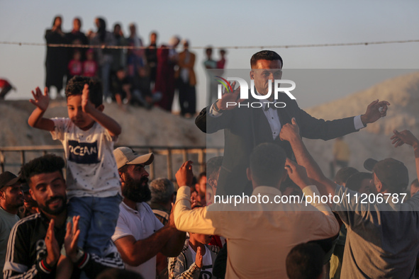 Grooms are celebrating during a mass wedding ceremony in Khan Yunis, in the southern Gaza Strip, on May 3, 2024, amid the ongoing conflict b...