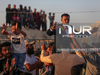 Grooms are celebrating during a mass wedding ceremony in Khan Yunis, in the southern Gaza Strip, on May 3, 2024, amid the ongoing conflict b...