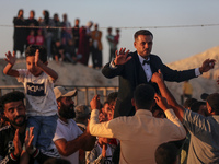 Grooms are celebrating during a mass wedding ceremony in Khan Yunis, in the southern Gaza Strip, on May 3, 2024, amid the ongoing conflict b...