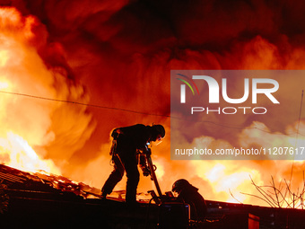 Firefighters are extinguishing the fire at the site of the drone attack in Kharkiv, Ukraine, on May 4, 2024. On the night of May 4, Russia a...