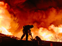 Firefighters are extinguishing the fire at the site of the drone attack in Kharkiv, Ukraine, on May 4, 2024. On the night of May 4, Russia a...