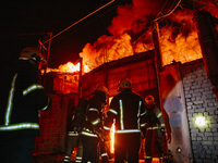 Firefighters are extinguishing the fire at the site of the drone attack in Kharkiv, Ukraine, on May 4, 2024. On the night of May 4, Russia a...