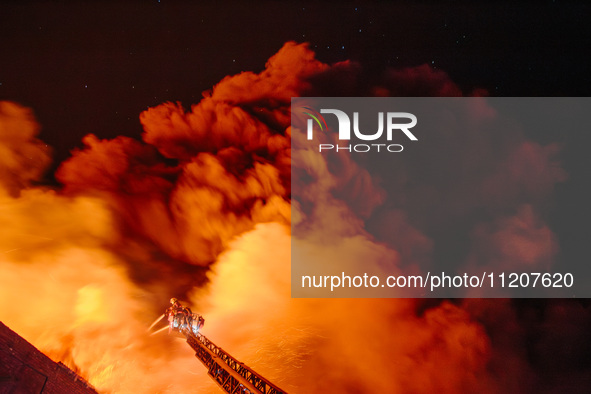 Firefighters are extinguishing the fire at the site of the drone attack in Kharkiv, Ukraine, on May 4, 2024. On the night of May 4, Russia a...