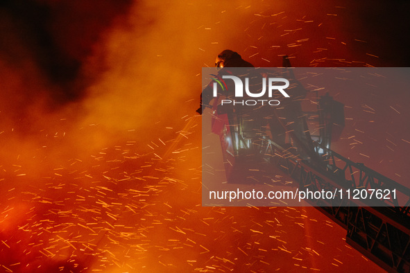 Firefighters are extinguishing the fire at the site of the drone attack in Kharkiv, Ukraine, on May 4, 2024. On the night of May 4, Russia a...