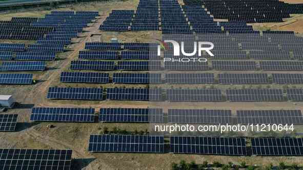 A drone is capturing images of photovoltaic power stations on both sides of the Beijing-Wei Expressway in Zhangjiakou, Hebei Province, China...