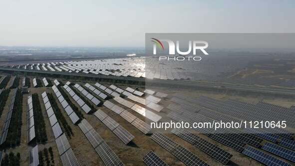 A drone is capturing images of photovoltaic power stations on both sides of the Beijing-Wei Expressway in Zhangjiakou, Hebei Province, China...