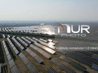 A drone is capturing images of photovoltaic power stations on both sides of the Beijing-Wei Expressway in Zhangjiakou, Hebei Province, China...