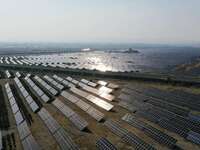 A drone is capturing images of photovoltaic power stations on both sides of the Beijing-Wei Expressway in Zhangjiakou, Hebei Province, China...