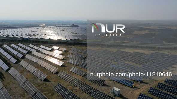 A drone is capturing images of photovoltaic power stations on both sides of the Beijing-Wei Expressway in Zhangjiakou, Hebei Province, China...