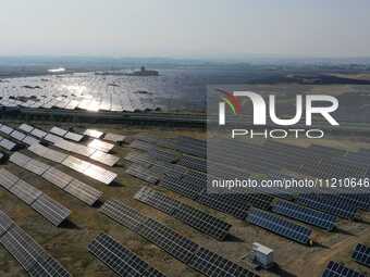 A drone is capturing images of photovoltaic power stations on both sides of the Beijing-Wei Expressway in Zhangjiakou, Hebei Province, China...