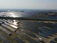 A drone is capturing images of photovoltaic power stations on both sides of the Beijing-Wei Expressway in Zhangjiakou, Hebei Province, China...