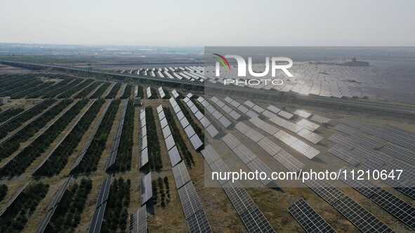 A drone is capturing images of photovoltaic power stations on both sides of the Beijing-Wei Expressway in Zhangjiakou, Hebei Province, China...