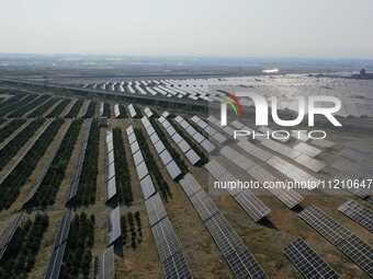 A drone is capturing images of photovoltaic power stations on both sides of the Beijing-Wei Expressway in Zhangjiakou, Hebei Province, China...