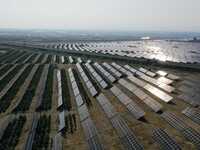 A drone is capturing images of photovoltaic power stations on both sides of the Beijing-Wei Expressway in Zhangjiakou, Hebei Province, China...