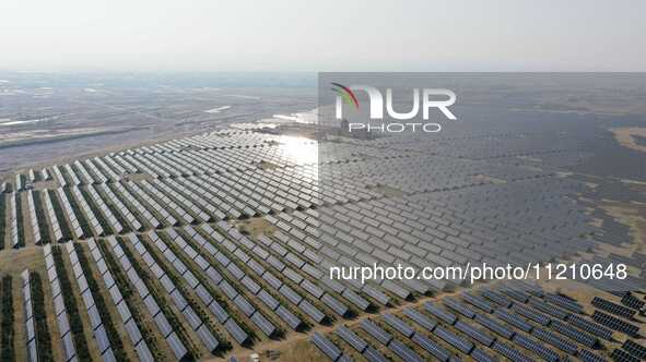 A drone is capturing images of photovoltaic power stations on both sides of the Beijing-Wei Expressway in Zhangjiakou, Hebei Province, China...