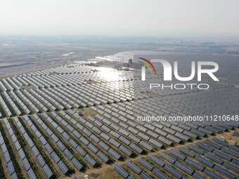 A drone is capturing images of photovoltaic power stations on both sides of the Beijing-Wei Expressway in Zhangjiakou, Hebei Province, China...