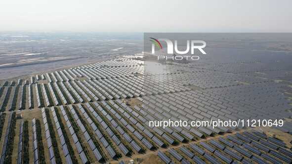 A drone is capturing images of photovoltaic power stations on both sides of the Beijing-Wei Expressway in Zhangjiakou, Hebei Province, China...