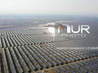 A drone is capturing images of photovoltaic power stations on both sides of the Beijing-Wei Expressway in Zhangjiakou, Hebei Province, China...