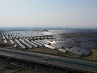 A drone is capturing images of photovoltaic power stations on both sides of the Beijing-Wei Expressway in Zhangjiakou, Hebei Province, China...