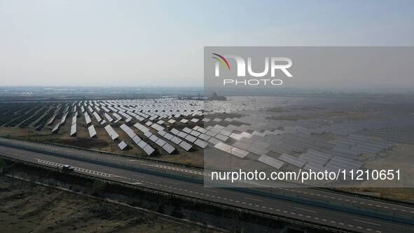 A drone is capturing images of photovoltaic power stations on both sides of the Beijing-Wei Expressway in Zhangjiakou, Hebei Province, China...