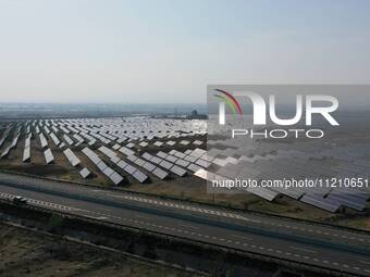 A drone is capturing images of photovoltaic power stations on both sides of the Beijing-Wei Expressway in Zhangjiakou, Hebei Province, China...