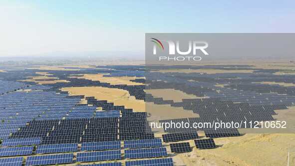 A drone is capturing images of photovoltaic power stations on both sides of the Beijing-Wei Expressway in Zhangjiakou, Hebei Province, China...