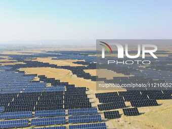 A drone is capturing images of photovoltaic power stations on both sides of the Beijing-Wei Expressway in Zhangjiakou, Hebei Province, China...