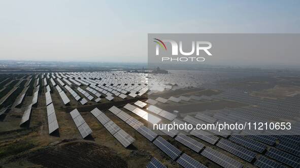 A drone is capturing images of photovoltaic power stations on both sides of the Beijing-Wei Expressway in Zhangjiakou, Hebei Province, China...