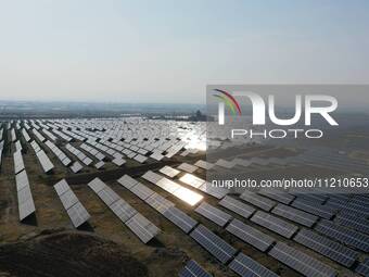 A drone is capturing images of photovoltaic power stations on both sides of the Beijing-Wei Expressway in Zhangjiakou, Hebei Province, China...