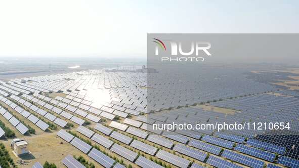 A drone is capturing images of photovoltaic power stations on both sides of the Beijing-Wei Expressway in Zhangjiakou, Hebei Province, China...