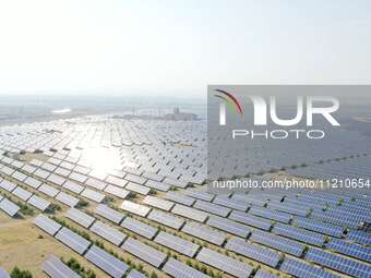 A drone is capturing images of photovoltaic power stations on both sides of the Beijing-Wei Expressway in Zhangjiakou, Hebei Province, China...