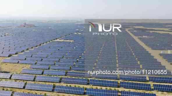 A drone is capturing images of photovoltaic power stations on both sides of the Beijing-Wei Expressway in Zhangjiakou, Hebei Province, China...