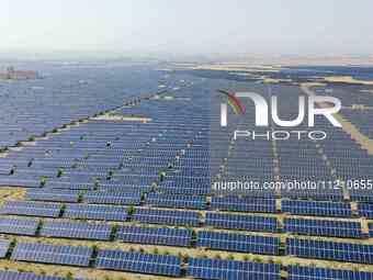 A drone is capturing images of photovoltaic power stations on both sides of the Beijing-Wei Expressway in Zhangjiakou, Hebei Province, China...