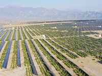 A drone is capturing images of photovoltaic power stations on both sides of the Beijing-Wei Expressway in Zhangjiakou, Hebei Province, China...