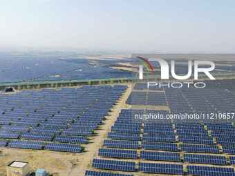 A drone is capturing images of photovoltaic power stations on both sides of the Beijing-Wei Expressway in Zhangjiakou, Hebei Province, China...