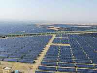 A drone is capturing images of photovoltaic power stations on both sides of the Beijing-Wei Expressway in Zhangjiakou, Hebei Province, China...